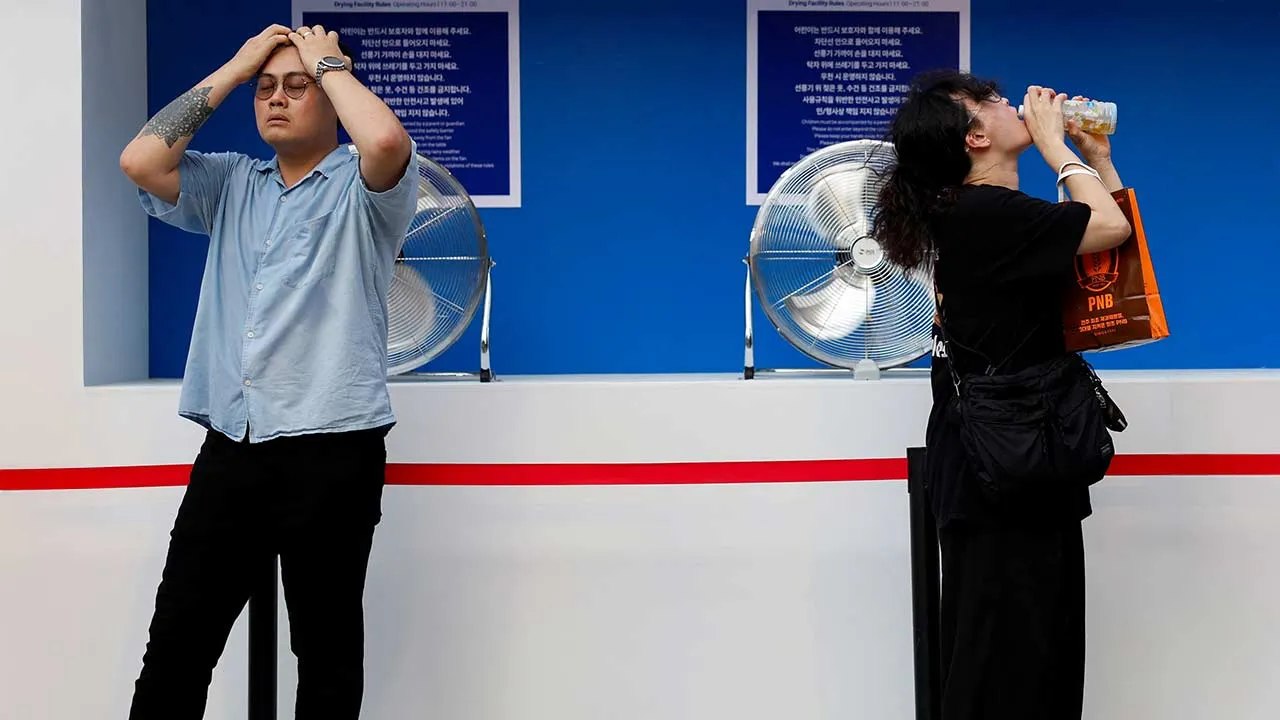 People cool off in front of fans during a heatwave in Seoul, South Korea, July 31, 2026. REUTERS/Kim Soo-hyeon