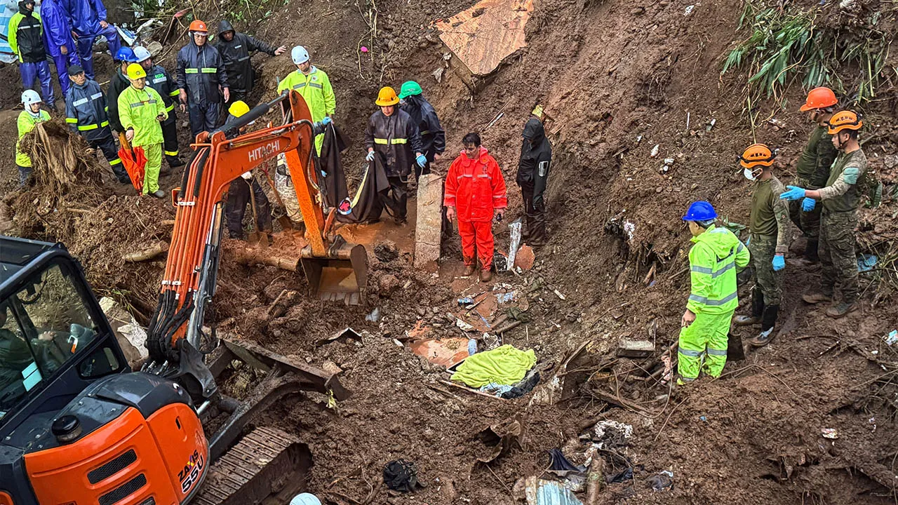 Rescuers continue search and rescue operations for missing residents a day after several houses were buried from a landslide due to heavy monsoon rains in Guisad Surong, Baguio City, northern Philippines, Monday, Aug. 10, 2026. (AP Photo/Harley Palangchao)