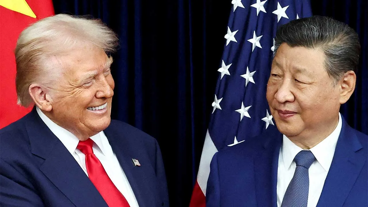 FILE PHOTO: U.S. President Donald Trump and Chinese President Xi Jinping react as they hold a bilateral meeting at Gimhae International Airport, on the sidelines of the Asia-Pacific Economic Cooperation (APEC) summit, in Busan, South Korea, October 30, 2025. REUTERS/Evelyn Hockstein/File Photo