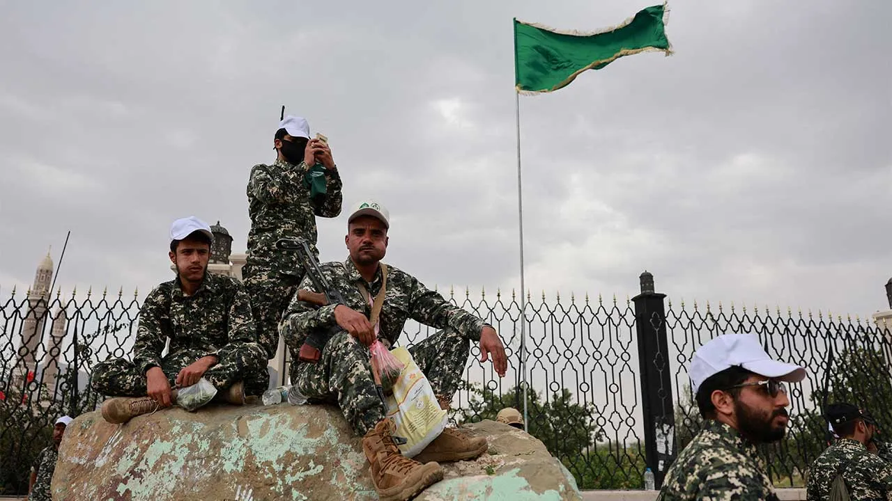 Members of Houthi security forces sit on a rock at the site of a rally held to commemorate Mawlid, marking the anniversary of Prophet Muhammad's birthday, in Sanaa, Yemen, August 25, 2026. REUTERS/Khaled Abdullah TPX IMAGES OF THE DAY