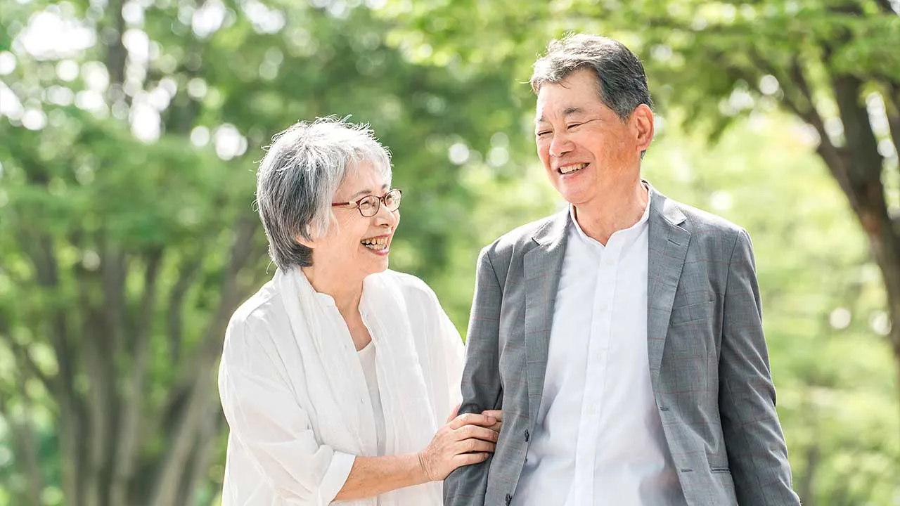 Senior couple walking in the park By buritora adobe stock images