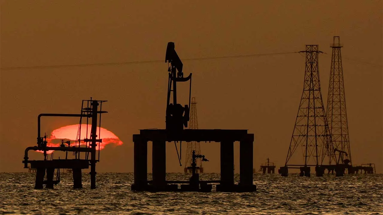 FILE PHOTO: Oil platforms and pumpjacks at Lake Maracaibo, as residents around the oil‑rich center of Maracaibo in Zulia state remain uncertain about new investments following recent legislative reforms allowing greater private participation in PDVSA and aimed at revitalizing the country's struggling oil sector, in Cabimas, Venezuela, January 26, 2026. REUTERS/Leonardo Fernandez Viloria/File Photo