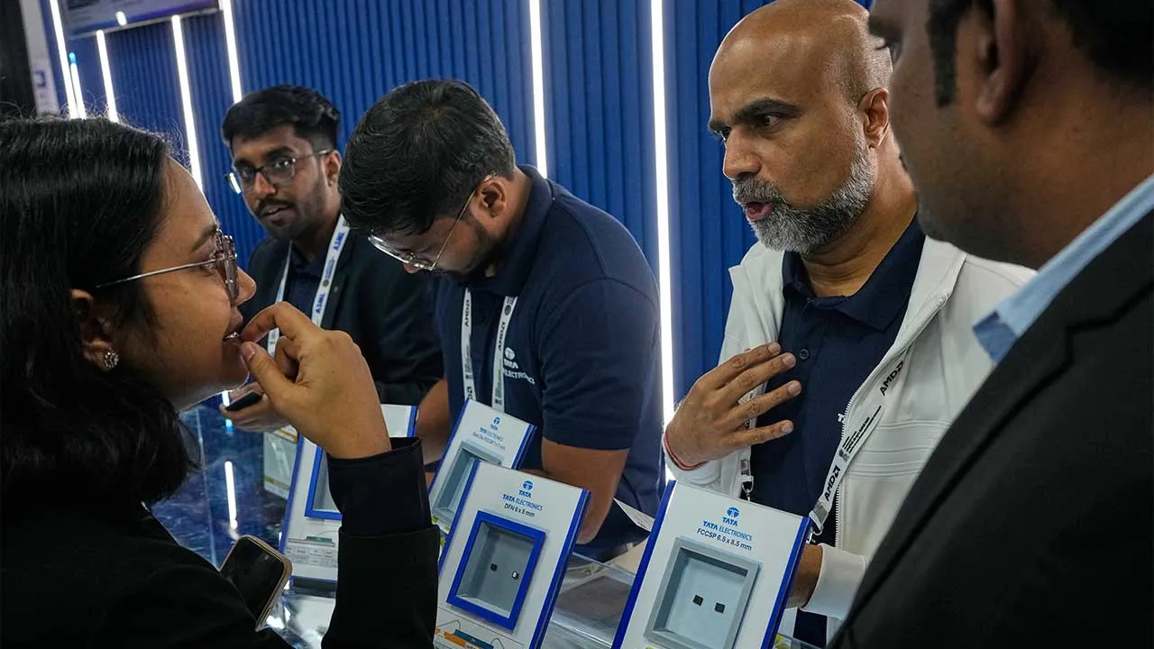A Tata Electronics exhibitor explains the applications of the company's semiconductor chips to a delegate at Semicon India 2026 in New Delhi, India, Friday, Sept. 18, 2026. (AP Photo/Manish Swarup)