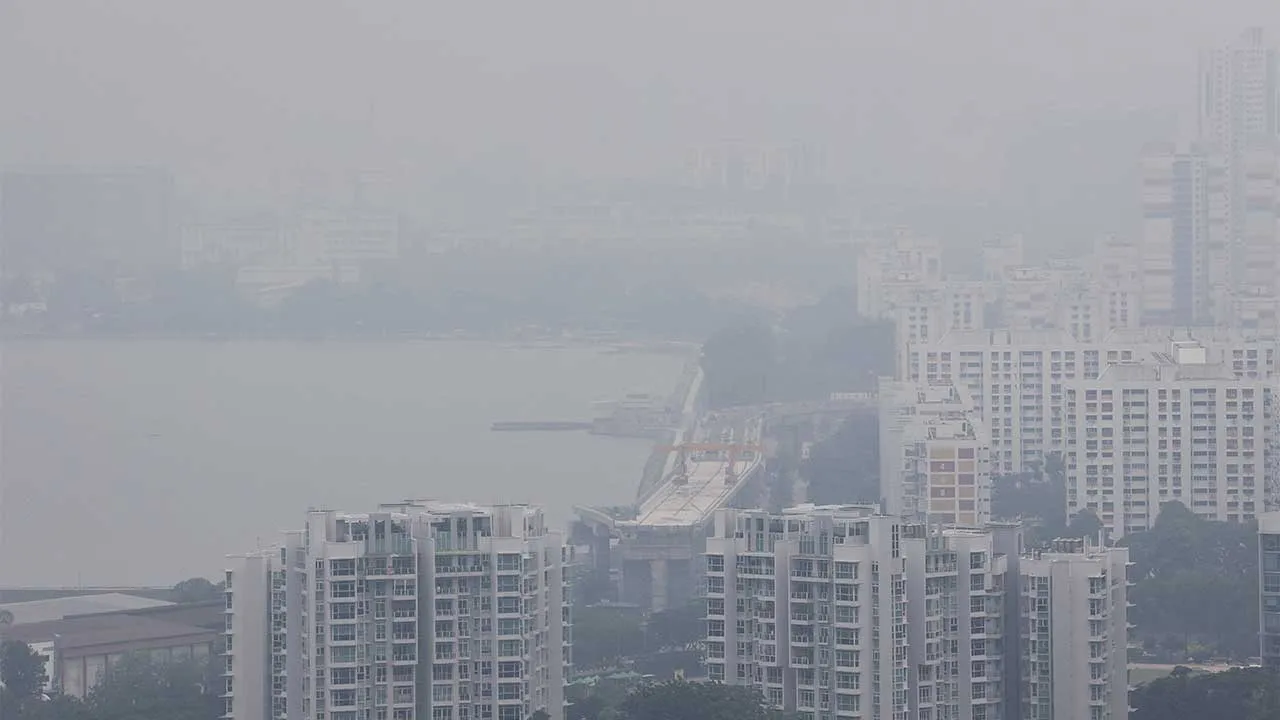 Haze shrouds commercial and residential buildings in the western side of Singapore on Monday as smoke from regional forest fires reduces visibility across the island city-state, in Singapore, September 14, 2026. REUTERS/Suhaimi Abdullah