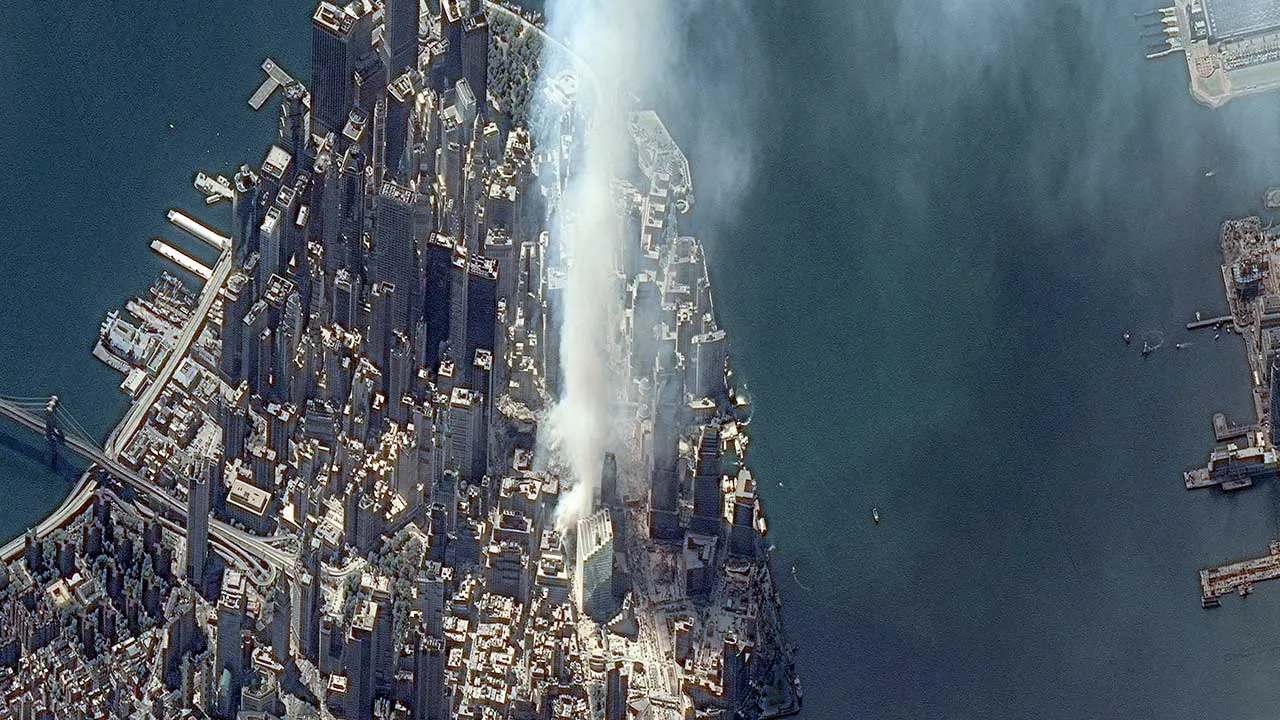 A satellite image shows a plume of smoke rising from the site of the World Trade Center after two planes crashed into the towers in the 9/11 attacks, in New York City, U.S., September 12, 2001. Vantor/Handout via REUTERS ATTENTION EDITORS - THIS IMAGE HAS BEEN SUPPLIED BY A THIRD PARTY. NO RESALE. NO ARCHIVE. MUST NOT OBSCURE LOGO. MANDATORY CREDIT. TPX IMAGES OF THE DAY