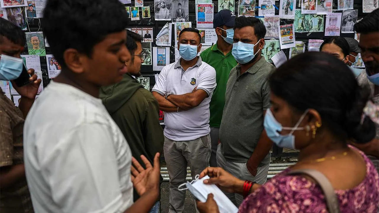 People gather in front of a wall displaying photographs of missing people outside Tribhuvan University Teaching Hospital following the deadly flash floods and mudslide, in Kathmandu, Nepal, September 2, 2026. REUTERS/Athit Perawongmetha