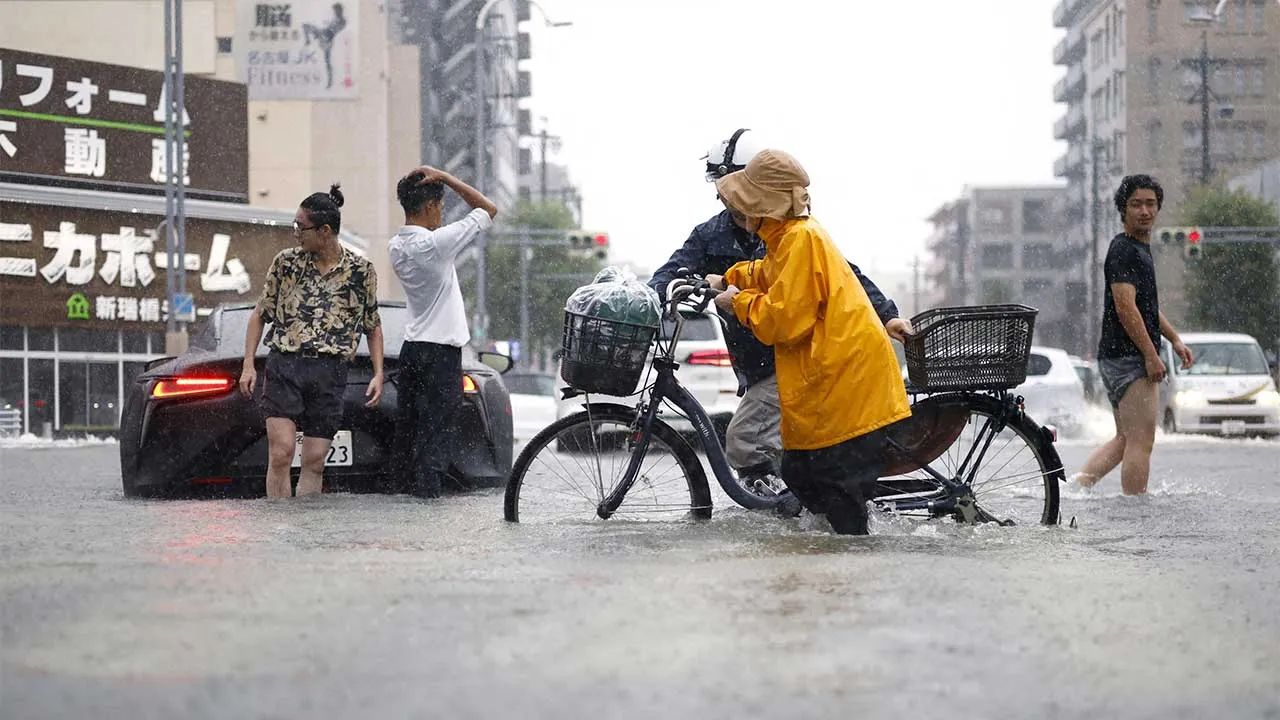 People move along a road flooded by heavy rain in Nagoya, central Japan September 8, 2026, in this photo taken by Kyodo. Mandatory credit Kyodo/via REUTERS ATTENTION EDITORS - THIS IMAGE HAS BEEN SUPPLIED BY A THIRD PARTY. MANDATORY CREDIT. JAPAN OUT. NO COMMERCIAL OR EDITORIAL SALES IN JAPAN. TPX IMAGES OF THE DAY