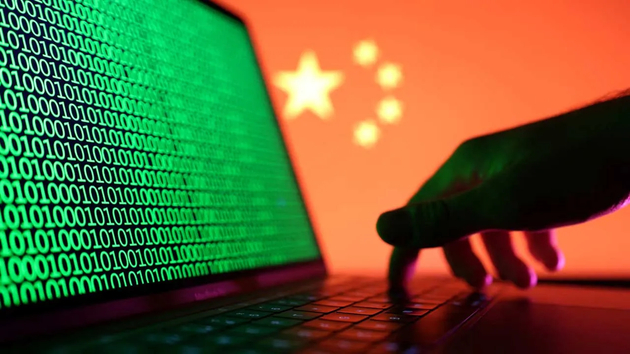 A hand is seen on a laptop with binary codes displayed in front of the Chinese flag in this illustration taken, August 19, 2022. REUTERS/Dado Ruvic/Illustration/ File Photo Purchase Licensing Rights