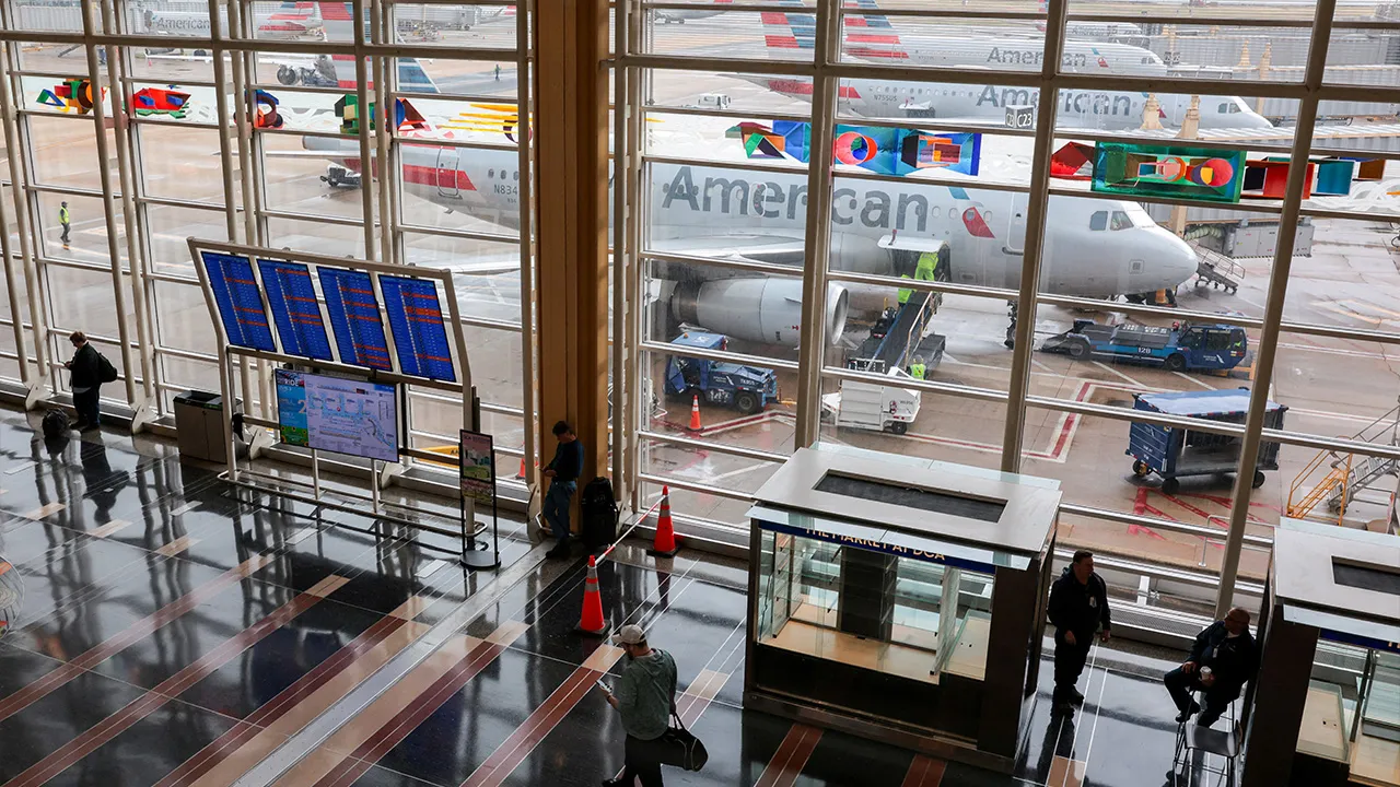 merican Airlines planes sit on the tarmac as a person moves through Ronald Reagan Washington National Airport in Arlington, Virginia, U.S., March 16, 2026. REUTERS