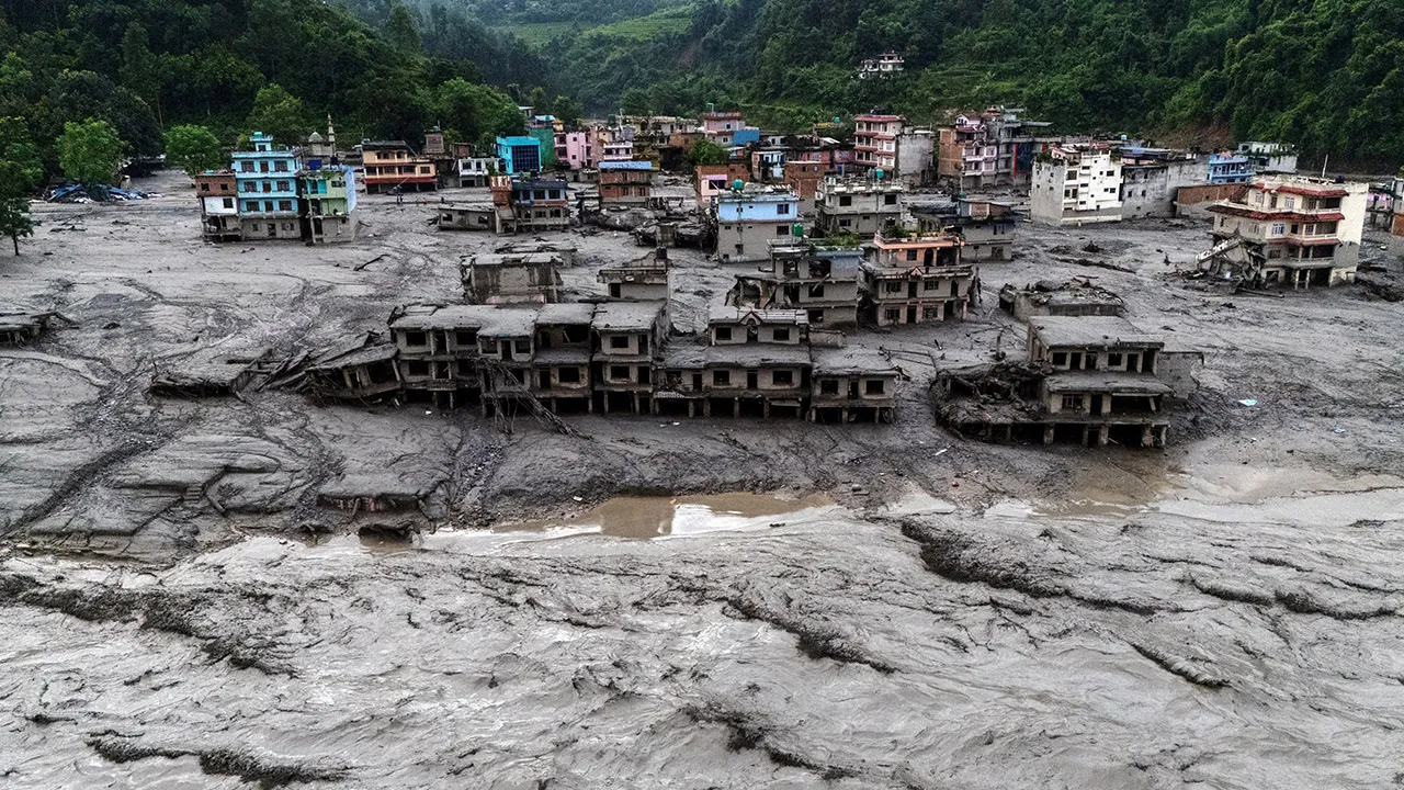  A drone view shows damaged buildings and houses covered in mud next to the Likhu River following deadly flash floods and mudslides, in Devighat, Nuwakot district, Nepal, August 30, 2026. REUTERS/Athit Perawongmetha