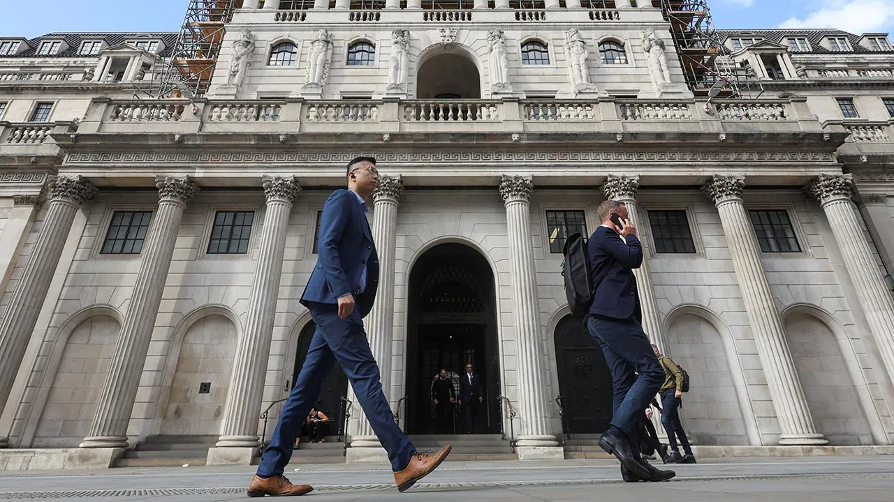 People walk past the Bank of England building in London, Britain, September 16, 2026. REUTERS/Corey Rudy