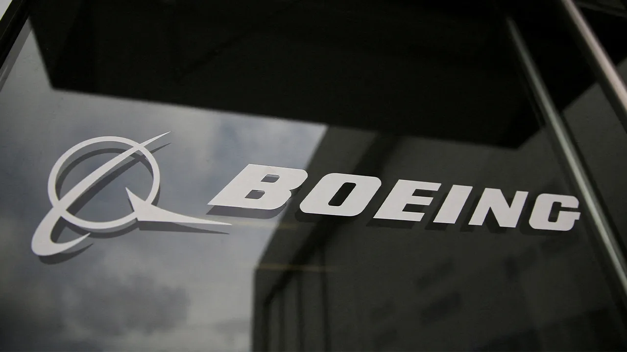 FILE PHOTO: The Boeing logo on the doors to the Boeing factory in Renton, Washington, U.S., April 15, 2026. REUTERS/Genna Martin/File Photo