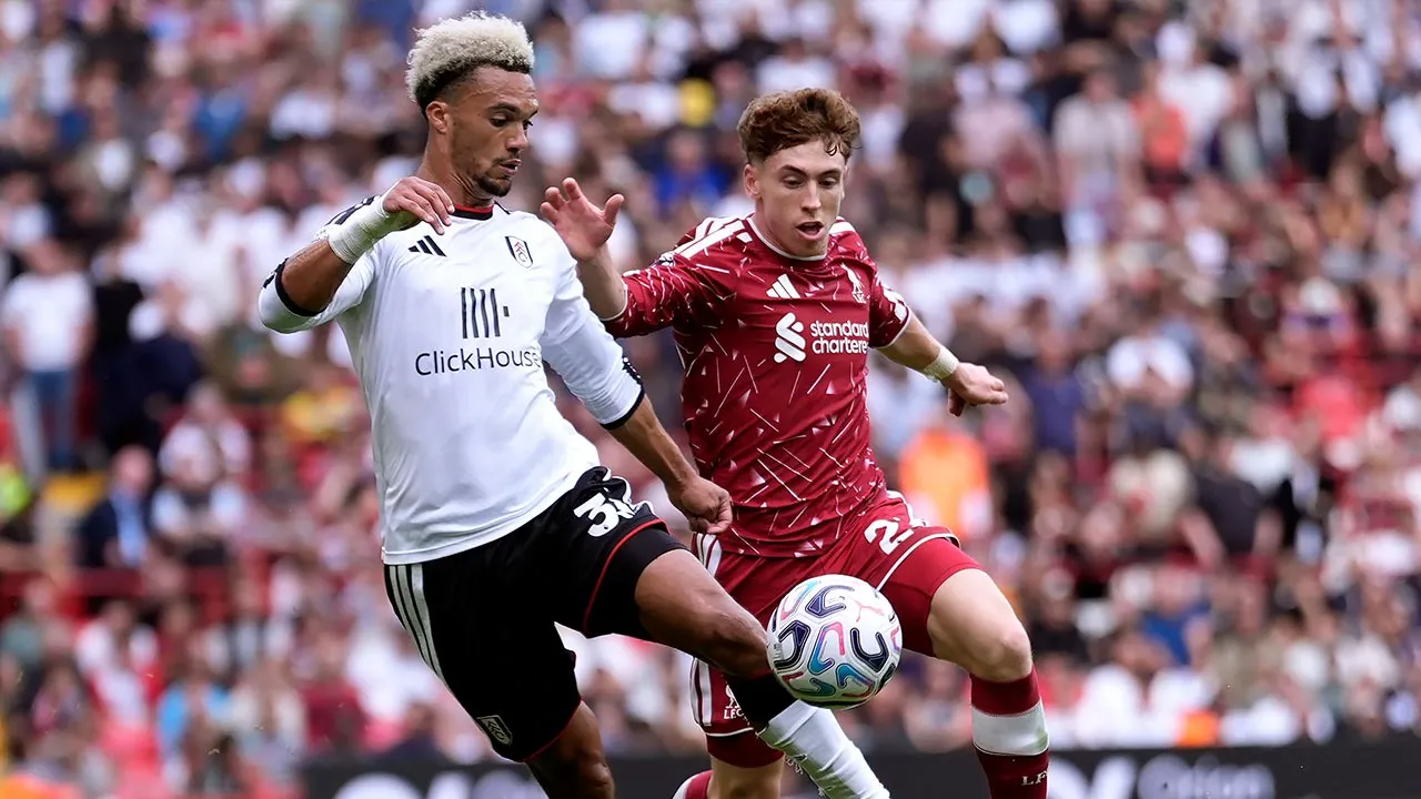 Fulham's Antonee Robinson, left, and Liverpool's Victor Munoz battle for the ball during the English Premier League soccer match between Liverpool and Fulham in Liverpool, England, Saturday Sept. 12, 2026. (Peter Byrne/PA via AP)