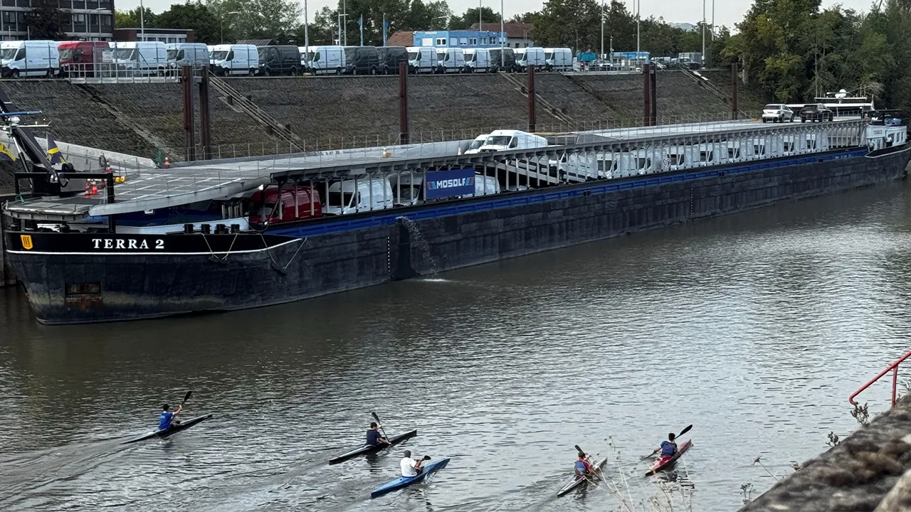 A cargo ship carrying Mercedes Sprinter vehicles is stuck in a harbour basin due to the low water level of the river Rhine, in Duesseldorf, Germany, September 29, 2026. Picture taken with a mobile phone. REUTERS/Petra Wischgol