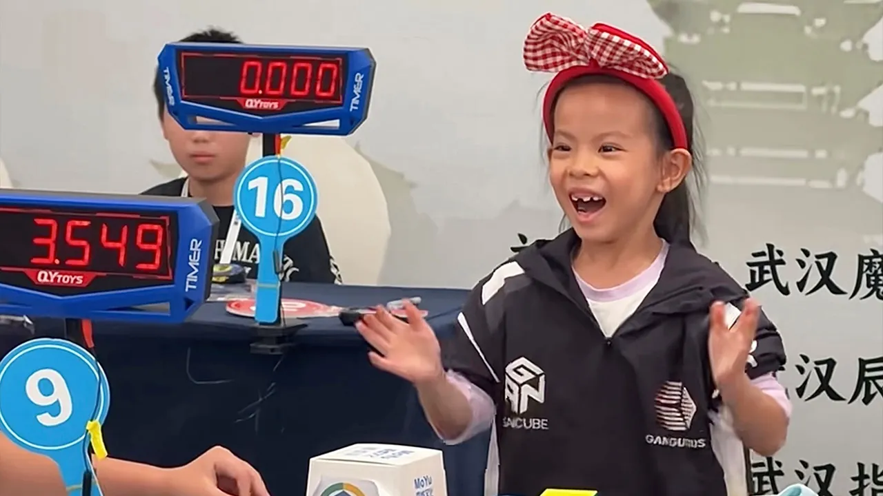 In this photo taken from video and released by YouTube@cuberootme, 6-year-old Lian Yunzhi reacts after solving a Rubik's cube at a World Cube Association-certified competition in the central Chinese city of Wuhan in central China's Hubei province on Sept. 13, 2026. (YouTube@cuberootme via AP)