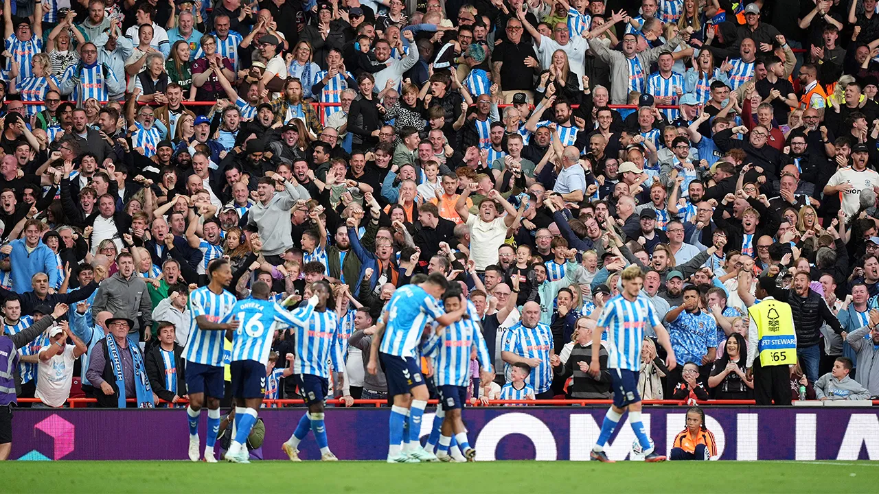 Coventry City fans celebrate after Jay Dasilva scores their side's first goal of the game during their English Premier League soccer match against Nottingham Forest in Nottingham, England, Saturday, Sept. 19, 2026. (Mike Egerton/PA via AP)