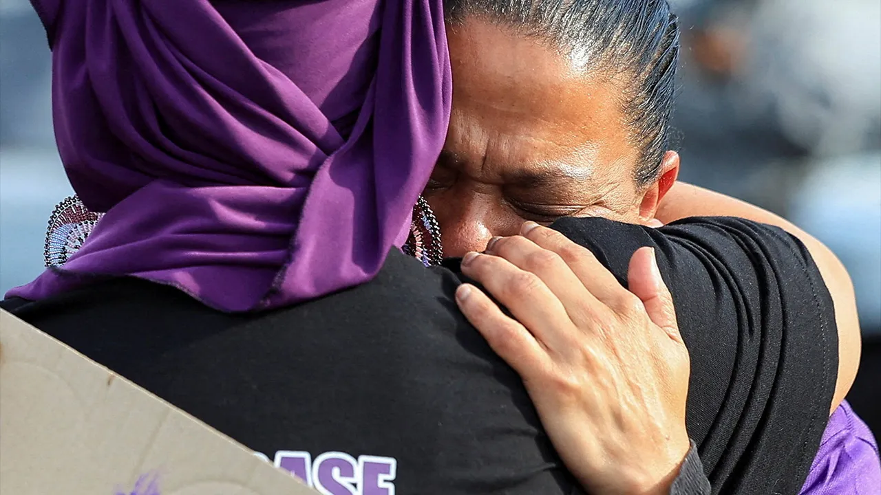 Demonstrators react as they greet each other ahead of an awareness walk for victims of gender-based violence and femicide, while calling for stronger action against violence against women following a spate of killings in recent months around Johannesburg, in Cape Town, South Africa, September 24, 2026. REUTERS/Esa Alexander