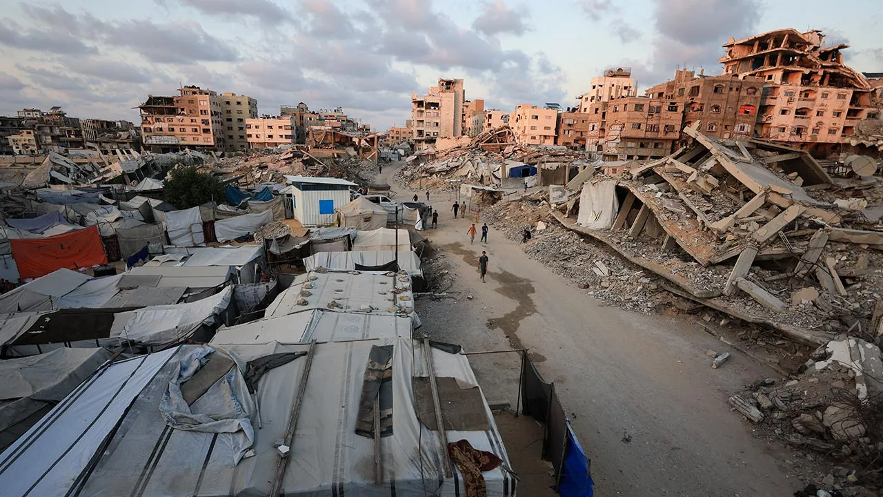 Palestinians walk past the rubble of residential buildings destroyed, in Gaza City, September 2, 2026. REUTERS/Dawoud Abu Alkas