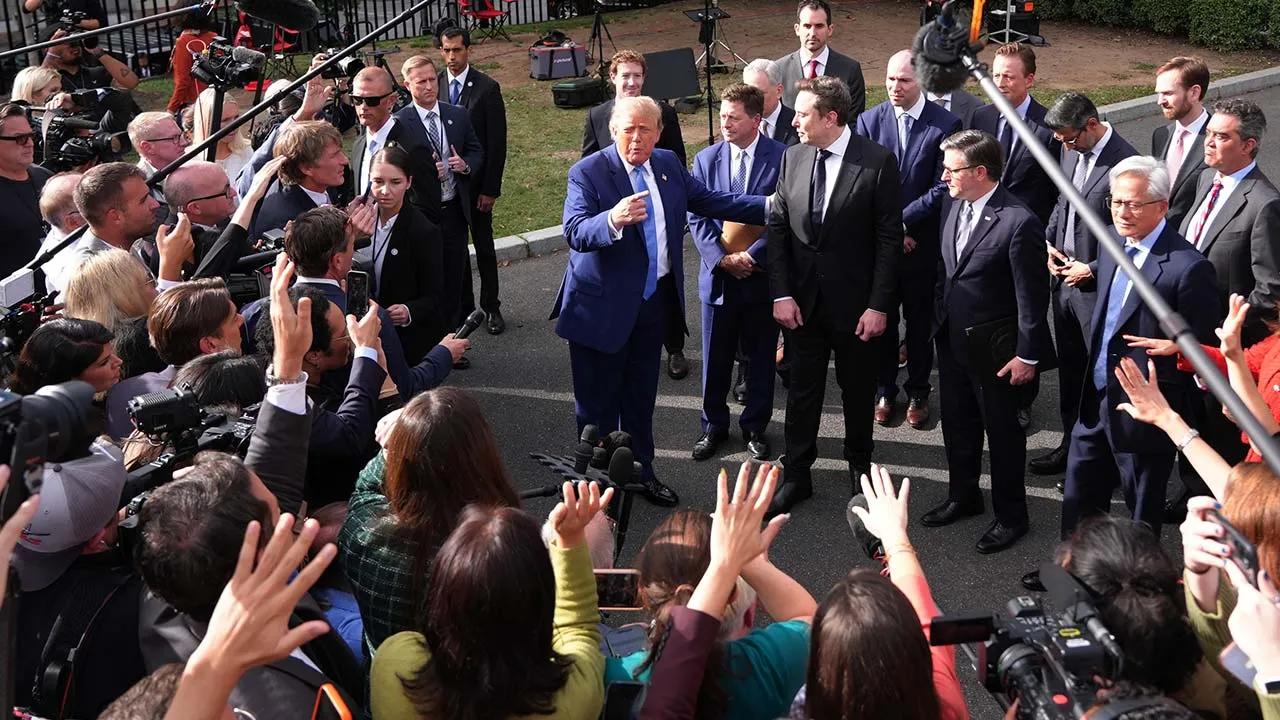 President Donald Trump gestures to Elon Musk as he speaks to reporters at the White House in Washington, Tuesday Sept. 29, 2026, after meeting with top executives of AI firms. (AP Photo/Jacquelyn Martin)
