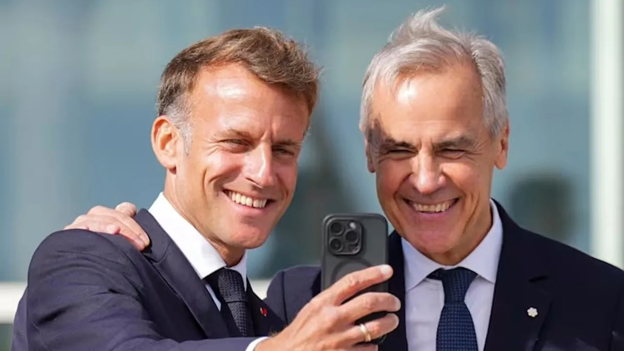 France's President Emmanuel Macron and Canada's Prime Minister Mark Carney pose for a selfie as they meet in the small French territory of Saint Pierre and Miquelon, France, on Sep 20, 2026. (Photo: Reuters/Chris Tanouye)