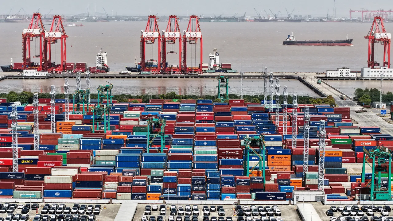 FILE PHOTO: FILE PHOTO: A drone view shows electric vehicles (EV) for export and containers sitting at a port in Shanghai, China April 13, 2025. China Daily via REUTERS ATTENTION EDITORS - THIS PICTURE WAS PROVIDED BY A THIRD PARTY. CHINA OUT. NO COMMERCIAL OR EDITORIAL SALES IN CHINA. TPX IMAGES OF THE DAY/File Photo/File Photo