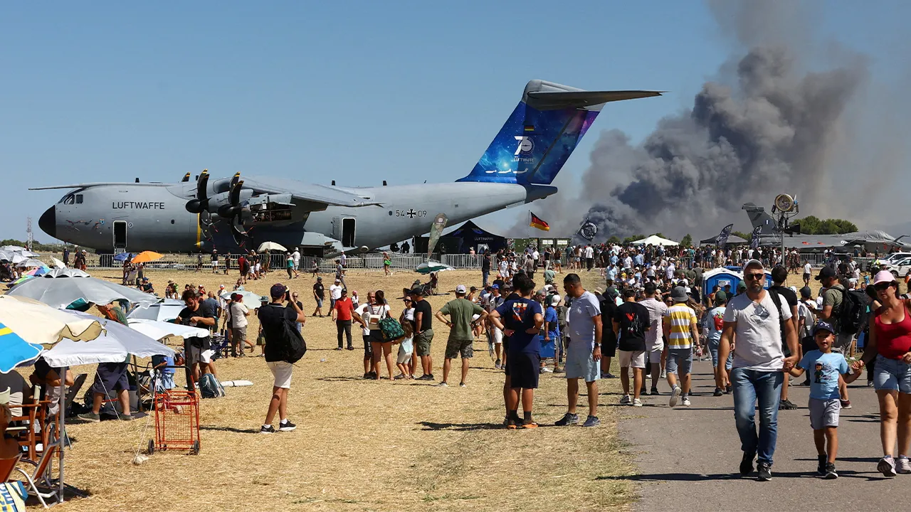 People watch as smoke rises following the crash of a Greek F-4 Phantom fighter jet during the Athens Flying Week air show in Tanagra, Greece, September 5, 2026. Nikos Mitrousias/Intime via REUTERS ATTENTION EDITORS - THIS PICTURE WAS PROVIDED BY A THIRD PARTY. NO RESALES. NO ARCHIVES. GREECE OUT. NO COMMERCIAL OR EDITORIAL SALES IN GREECE TPX IMAGES OF THE DAY