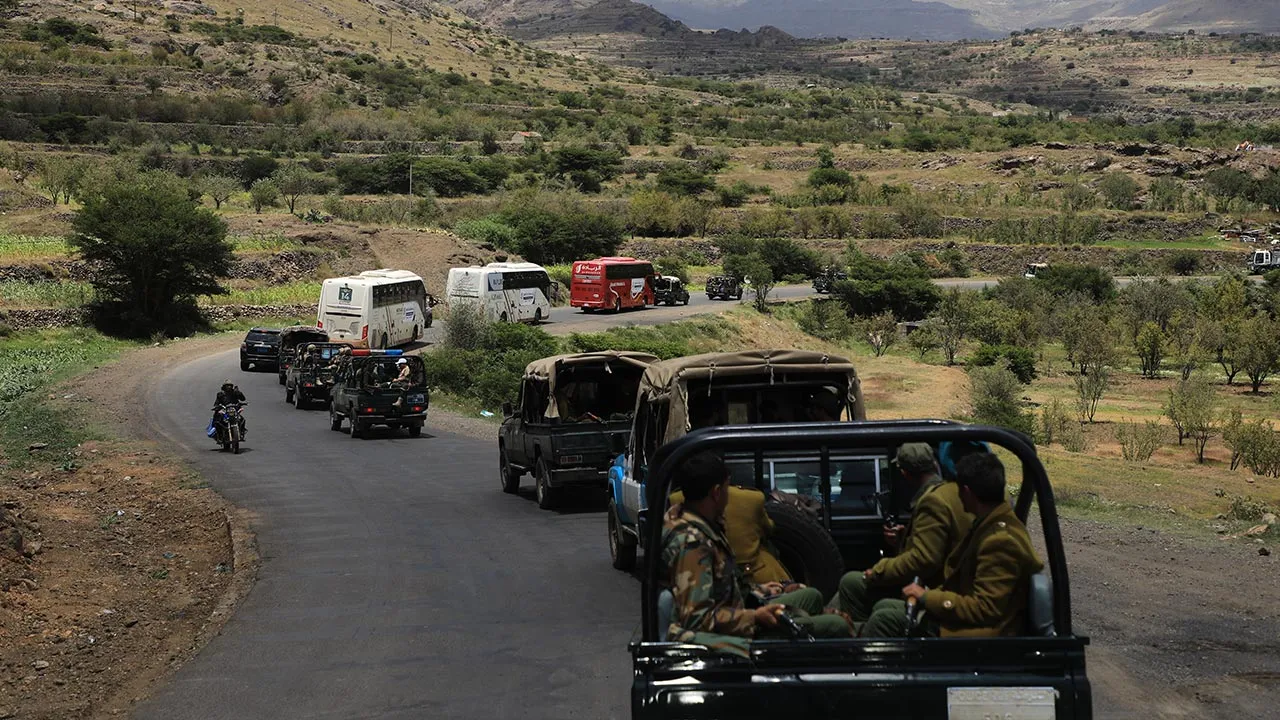 Houthi fighters escort a convoy carrying prisoners freed in Mokha through the Bani Matar district on its way to Sanaa, Yemen, Saturday, Sept. 12, 2026, following the Houthi takeover of the southern Red Sea port city. (AP Photo/STR)