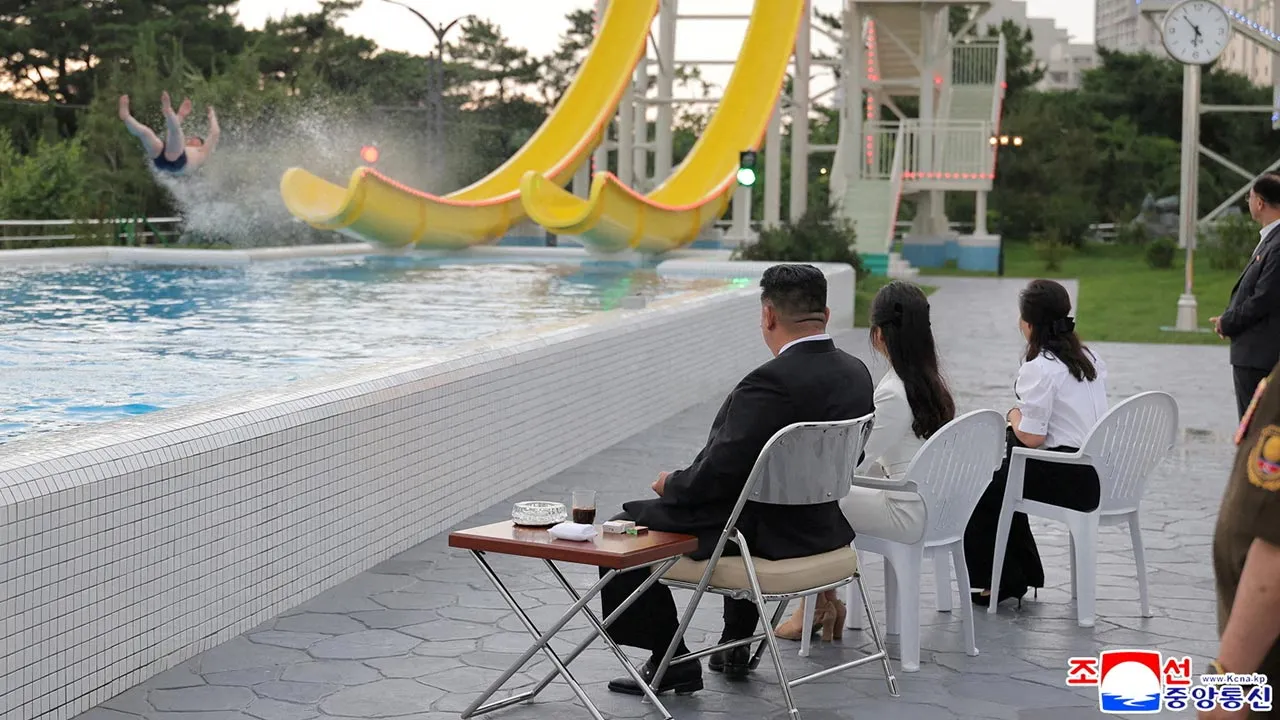 North Korean leader Kim Jong Un and his daughter Kim Ju Ae watch a person sliding down a slide during a ceremony to celebrate the completion of the Wonsan Kalma Coastal Tourist Zone, in Wonsan, North Korea, June 24, 2025. KCNA via REUTERS