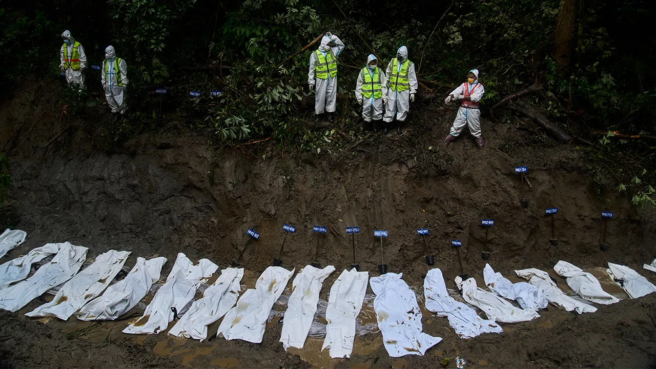 Nepal police personnel prepare the bodies of flash flood victims for a mass burial in Kathmandu, Nepal, Tuesday, Sept. 1, 2026. (AP Photo/Niranjan Shrestha)