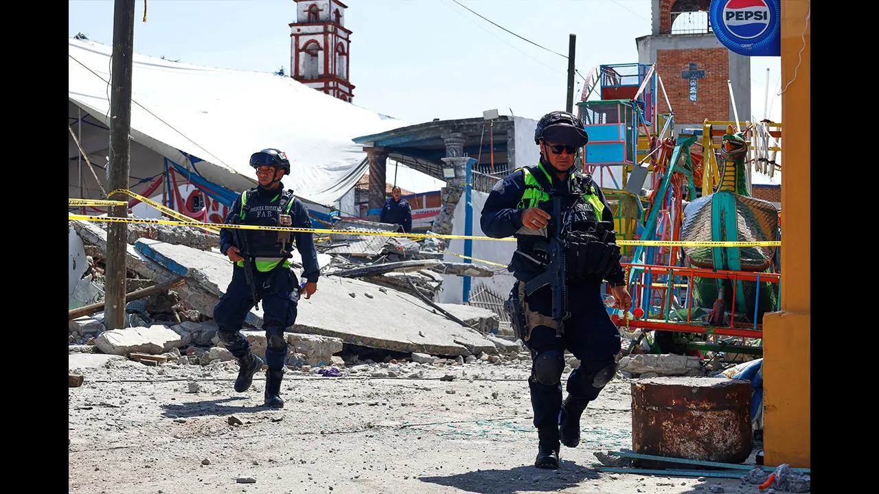 Mexico State police inspect the area destroyed by a fireworks explosion by the Santa María Canchesdá church in Temascalcingo, Mexico, Sunday, Sept. 6, 2026. (AP Photo/Ramses Mercado)