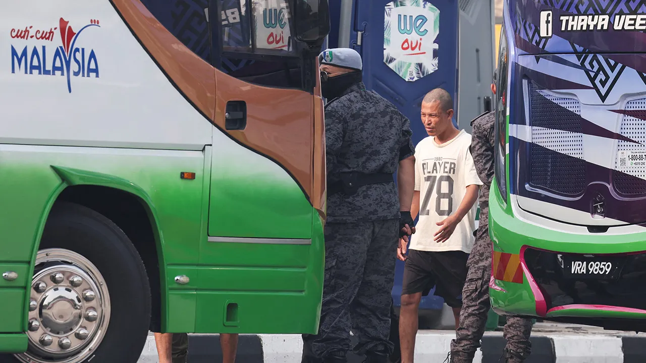 A Myanmar national due to be repatriated from Malaysia stands at Lumut, Malaysia, September 29, 2026. REUTERS/Hasnoor Hussain