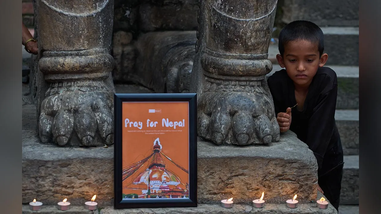 A young Nepali boy watches as people light candles during a candlelight vigil for victims of the floods in Nepal and Tibet, at Durbar Square in Kathmandu, Nepal, Saturday, Sept. 5, 2026. (AP Photo/Dar Yasin)