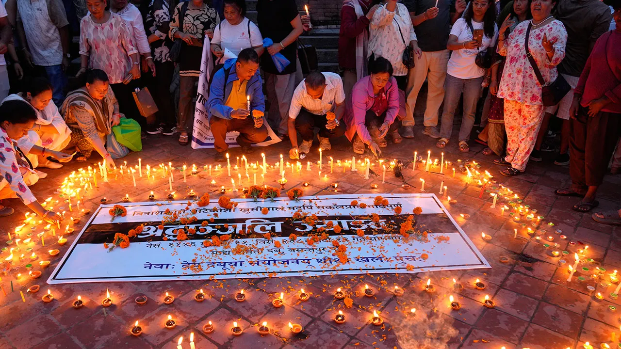 People light candles and pray during a day of mourning for those killed in the Aug. 26 floods in Kathmandu, Nepal, Monday, Sept. 7, 2026. (AP Photo/Dar Yasin)