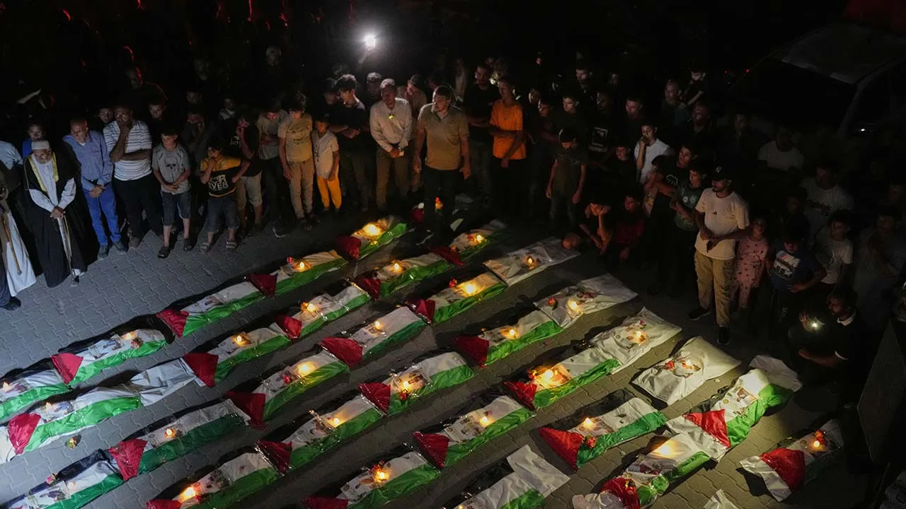 Mourners light candles by the bodies of Palestinians recovered from the rubble of homes demolished during the Israel-Hamas war in Gaza City, Saturday, Sept. 5, 2026. (AP Photo/Jehad Alshrafi)