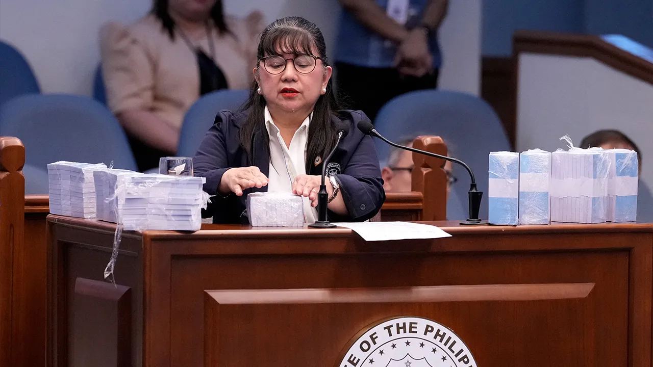 Former Office of the Vice President special disbursing officer Gina Acosta is surrounded by mock money presented during the impeachment trial of Philippine Vice President Sara Duterte at the Philippine Senate in Pasay city, Metro Manila, Philippines, Monday, Aug. 17, 2026. Aaron Favila/Pool via REUTERS