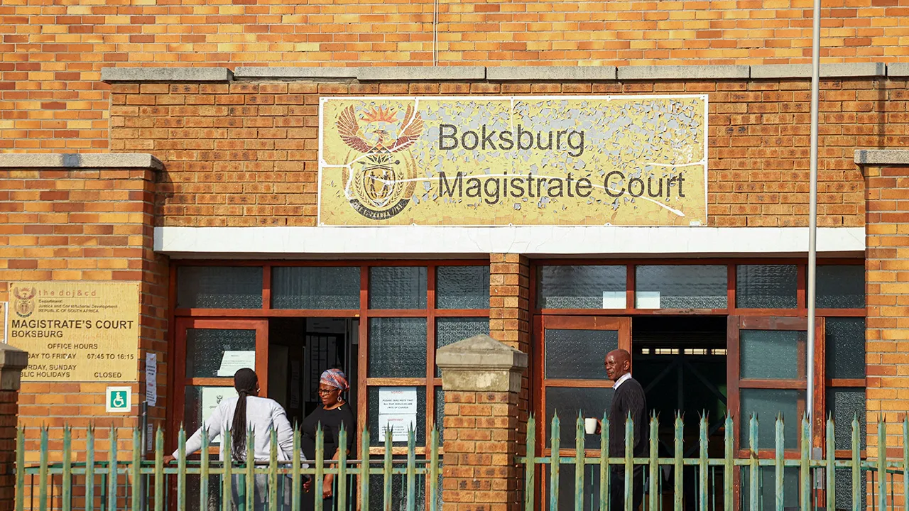 Court employees stand at the entrance of the Boksburg Magistrate's Court, where two women, among three suspects arrested over the weekend, appeared in connection with the death of a woman whose body was found east of Johannesburg last week, amid renewed public concern over gender-based violence, in Boksburg, east of Johannesburg, South Africa, September 21, 2026. REUTERS