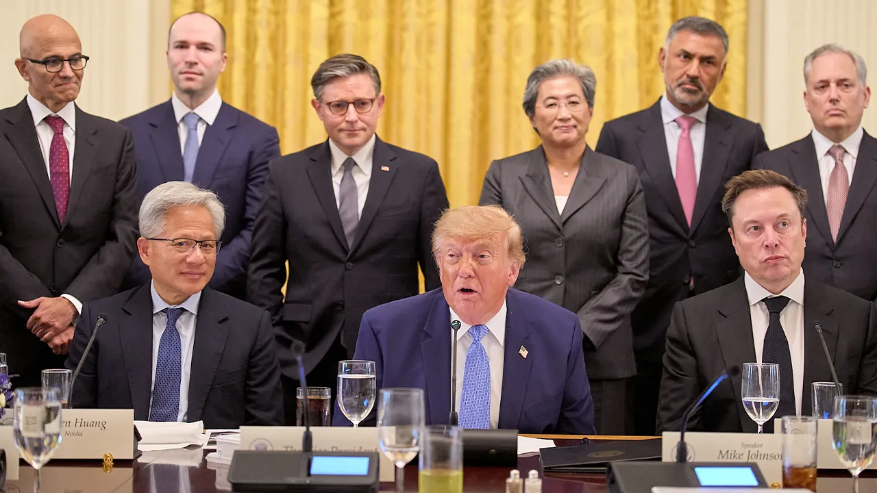 President Donald Trump, center, next to Nvidia CEO Jensen Huang, left, and Elon Musk, right, speaks in the East Room of the White House in Washington, Tuesday Sept. 29, 2026, surrounded by top executives of AI firms including, from top left, Microsoft CEO Satya Nadella, Greg Brockman, President of OpenAI, House Speaker Mike Johnson, AMD CEO Lisa Su, Palo Alto Networks Chief Executive Nikesh Arora, and David Sacks. (AP Photo/Jacquelyn Martin)