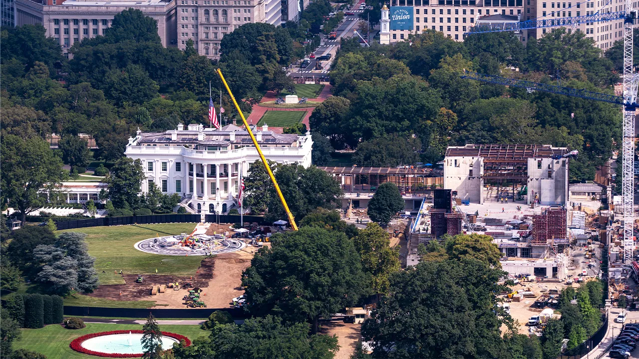 Construction continues on a helipad, left, on the South Lawn of the White House and and the new White House ballroom, right, as seen from the Washington Monument in Washington, Friday, Aug. 28, 2026. (AP Photo/J. Scott Applewhite)