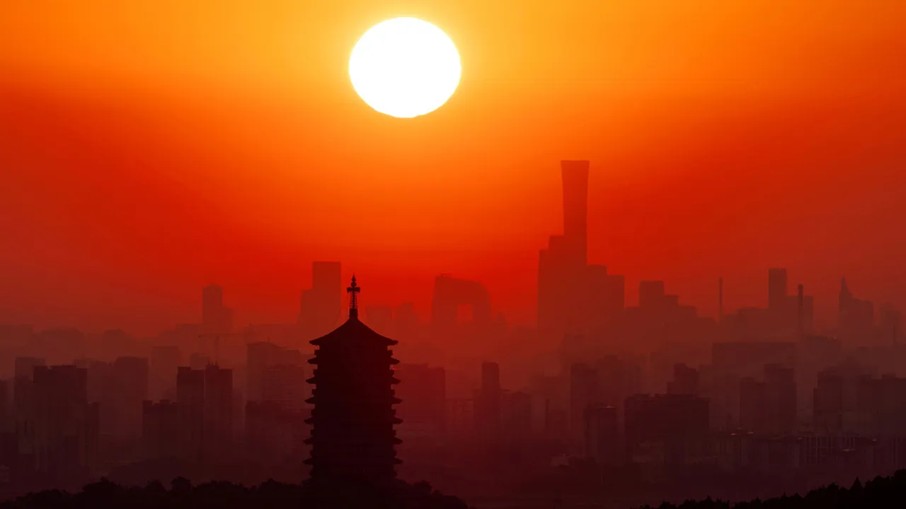 Yongding Pagoda stands against the rising sun and Beijing skyline, with skyscrapers in the Central Business District, including the CITIC Tower and CCTV headquarters, seen in the distance, in Beijing, China, September 3, 2026. REUTERS/Maxim Shemetov