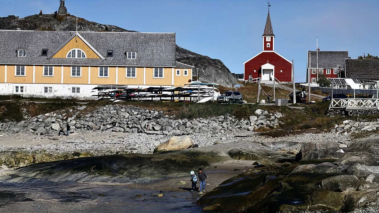 Two children play on the beach in the old harbour area of Nuuk, Greenland, September 22, 2026. REUTERS/Tim Barsoe TPX IMAGES OF THE DAY
