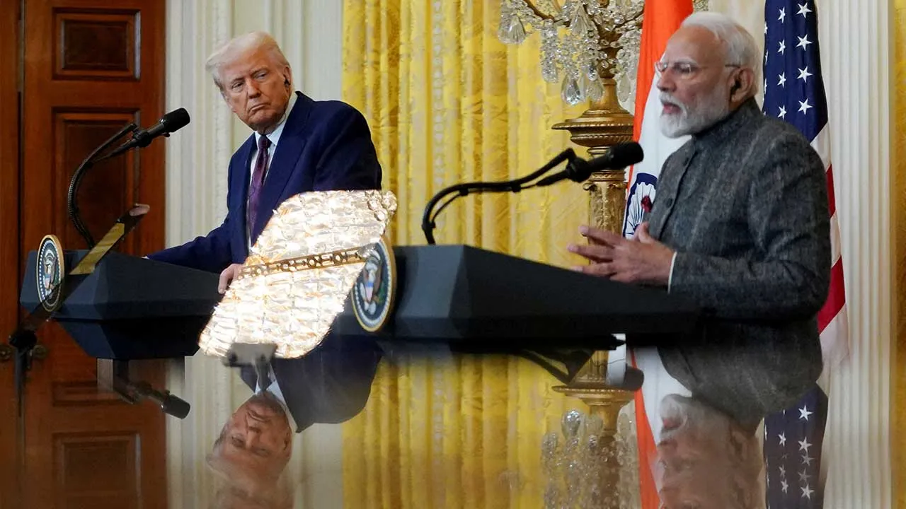 FILE PHOTO: U.S. President Donald Trump and Indian Prime Minister Narendra Modi are pictured in a mirror as they attend a joint press conference at the White House in Washington, D.C., U.S., February 13, 2025. REUTERS/Nathan Howard/File Photo