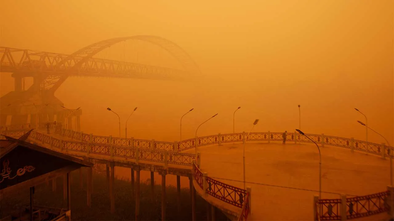 A person stands on a promenade as haze from wildfires shrouds the area, on the bank of the Kahayan River in Palangka Raya, Central Kalimantan province, Indonesia, October 14, 2026. REUTERS/Arief Rahman Septian Prathama TPX IMAGES OF THE DAY