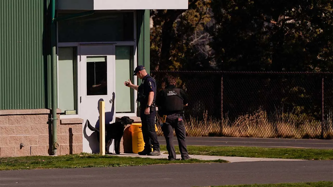 State troopers with a dog work in the schoolyard at Silver Rail Elementary School, the day after a shooting, in Bend, Oregon, U.S., October 16, 2026. REUTERS/David Ryder