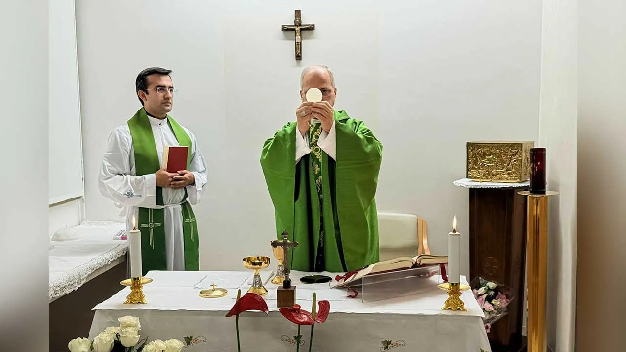 This picture, released by Vatican Media on Friday, Oct. 16, 2026, shows Pope Leo XIV, flanked by his personal secretary, Monsignor Edgard Iván Rimaycuna Inga, left, celebrating Mass at the Agostino Gemelli Polyclinic in Rome, where he is recovering after having cancer removed from his right lung. (Vatican Media via AP)