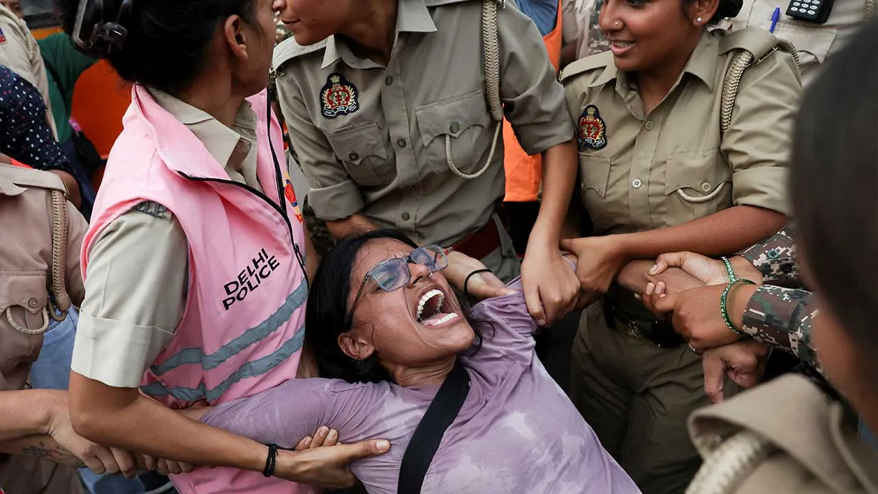 A protester reacts while being detained by security personnel during a protest seeking the resignation of India's Chief Election Commissioner Gyanesh Kumar, in New Delhi, India, October 11, 2026. REUTERS/Priyanshu Singh