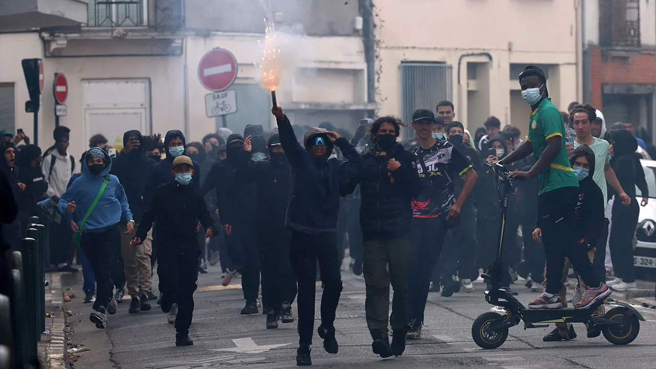 French masked high school students react in a street amid clashes near the Lycee Deodat-de-Severac high school as part of nationwide protests by high school students to demand the hiring of substitute teachers, increased resources and better learning conditions, in Toulouse as more than 400 schools remain closed following days of student protests that have escalated into violence in some places, France, October 2, 2026. REUTERS/Nacho Doce TPX IMAGES OF THE DAY