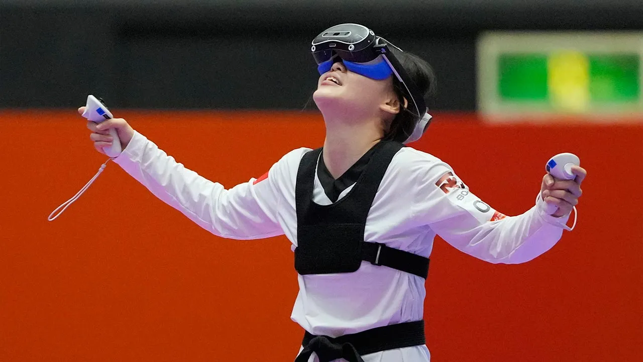 Vietnam's Chau Ngoc Tuyet Sang celebrates after defeating Singapore's Darren Yap Zong Han in their mixed individual virtual taekwondo semifinal match at the Asian Games in Toyohashi, Japan, Friday, Oct. 2, 2026. (AP Photo/Dita Alangkara