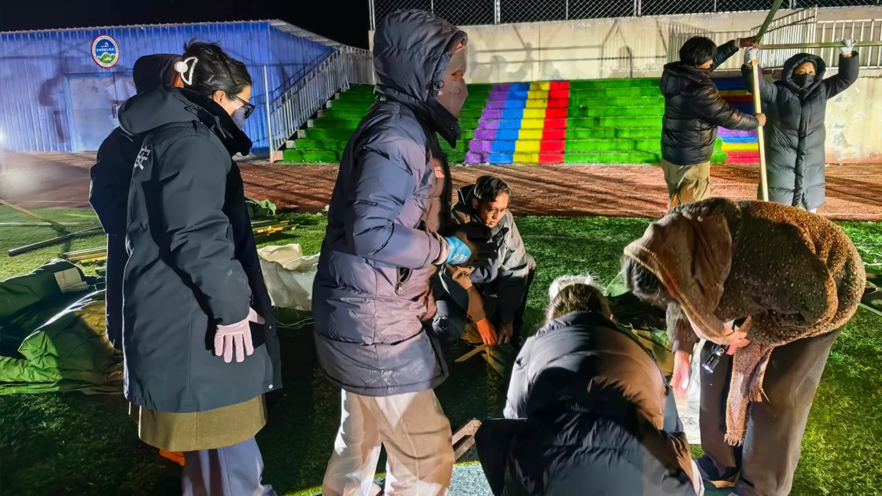 In this photo released by Xinhua News Agency, people set up tents for quake-affected residents at a primary school following an earthquake hit in Baqen County of Nagqu City in southwest Tibet autonomous region on Friday, Oct. 23, 2026. (Xinhua via AP)