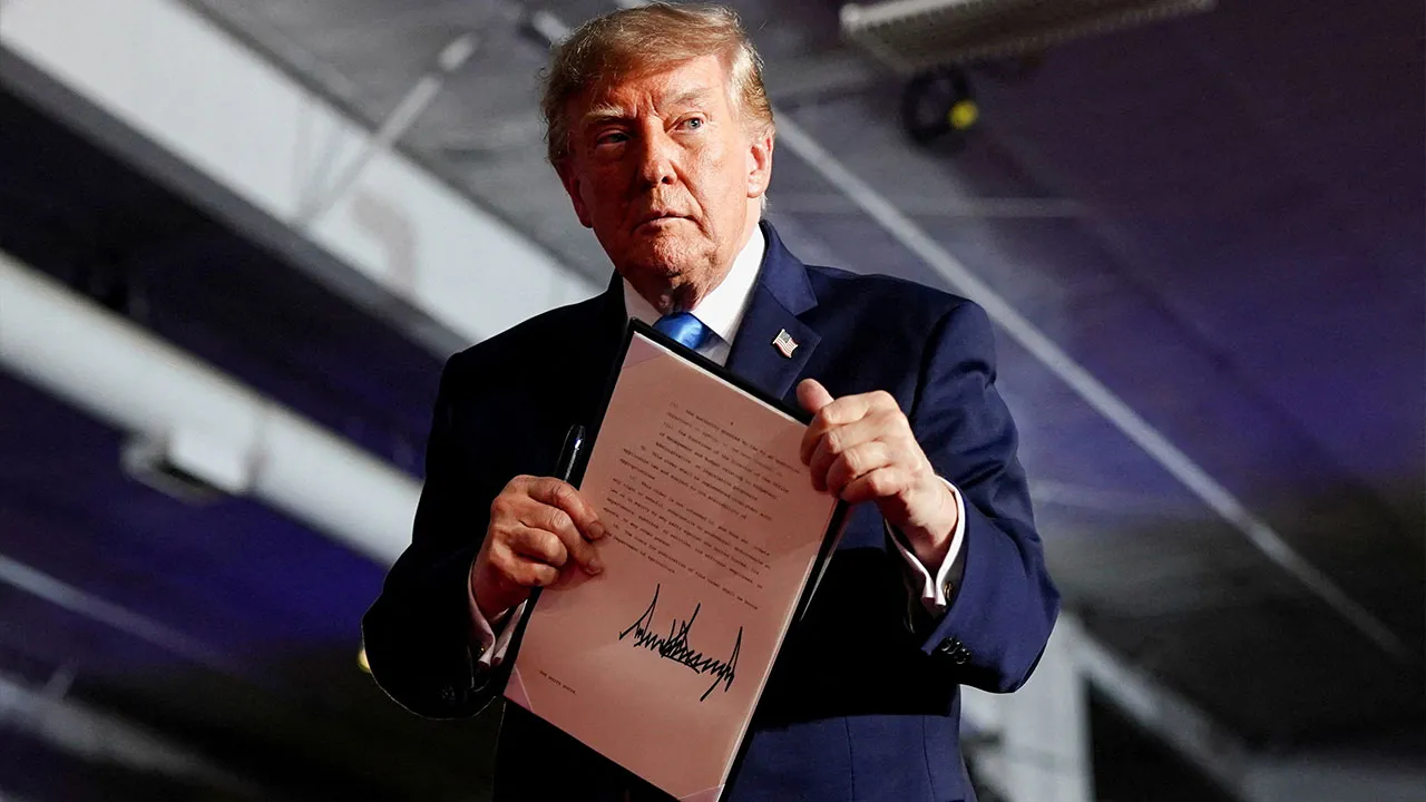 US President Donald Trump holds an Executive Order after signing it onstage during a rally at Pinnacle Bank Expo Center in Grand Island, Nebraska, US, October 5, 2026. REUTERS/Nathan Howard TPX IMAGES OF THE DAY