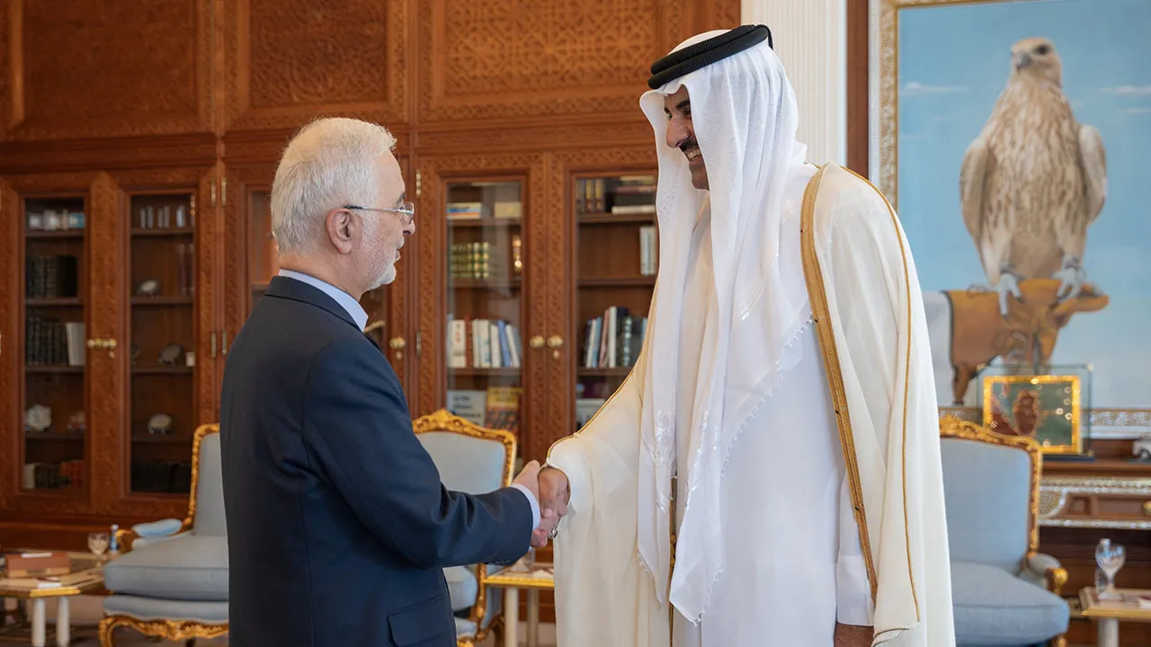 Qatar's Emir Sheikh Tamim bin Hamad Al Thani shakes hands with Iranian Interior Minister Eskandar Momeni in Doha, Qatar, October 6, 2026. Amiri Diwan/Handout via REUTERS